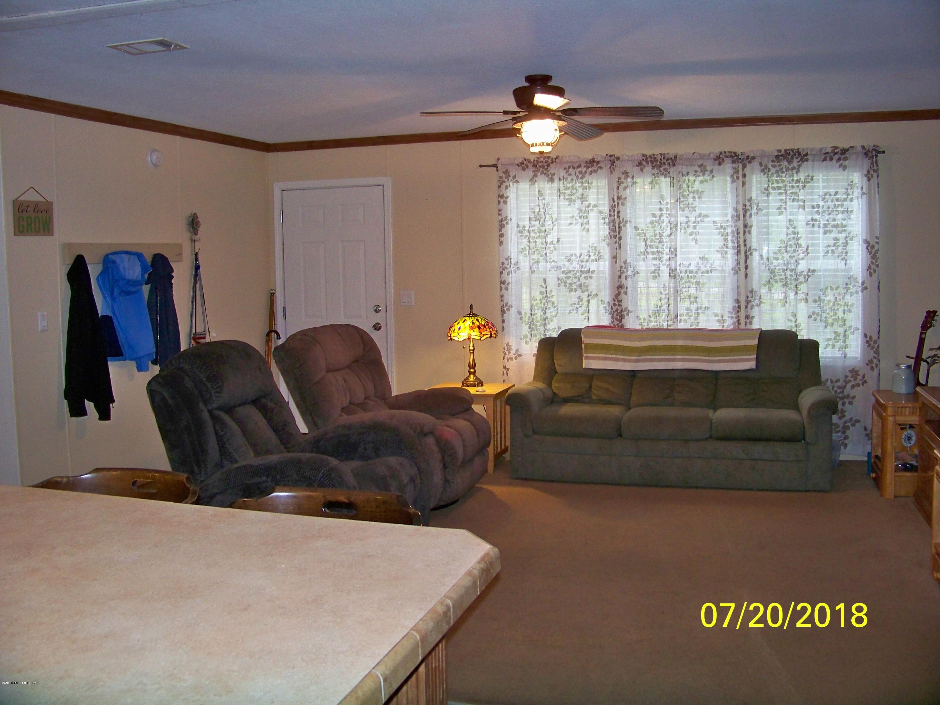 54314 Lawhon Road West Callahan, FL 32011 - Photo 5 of 30 a living room with furniture and a large window
