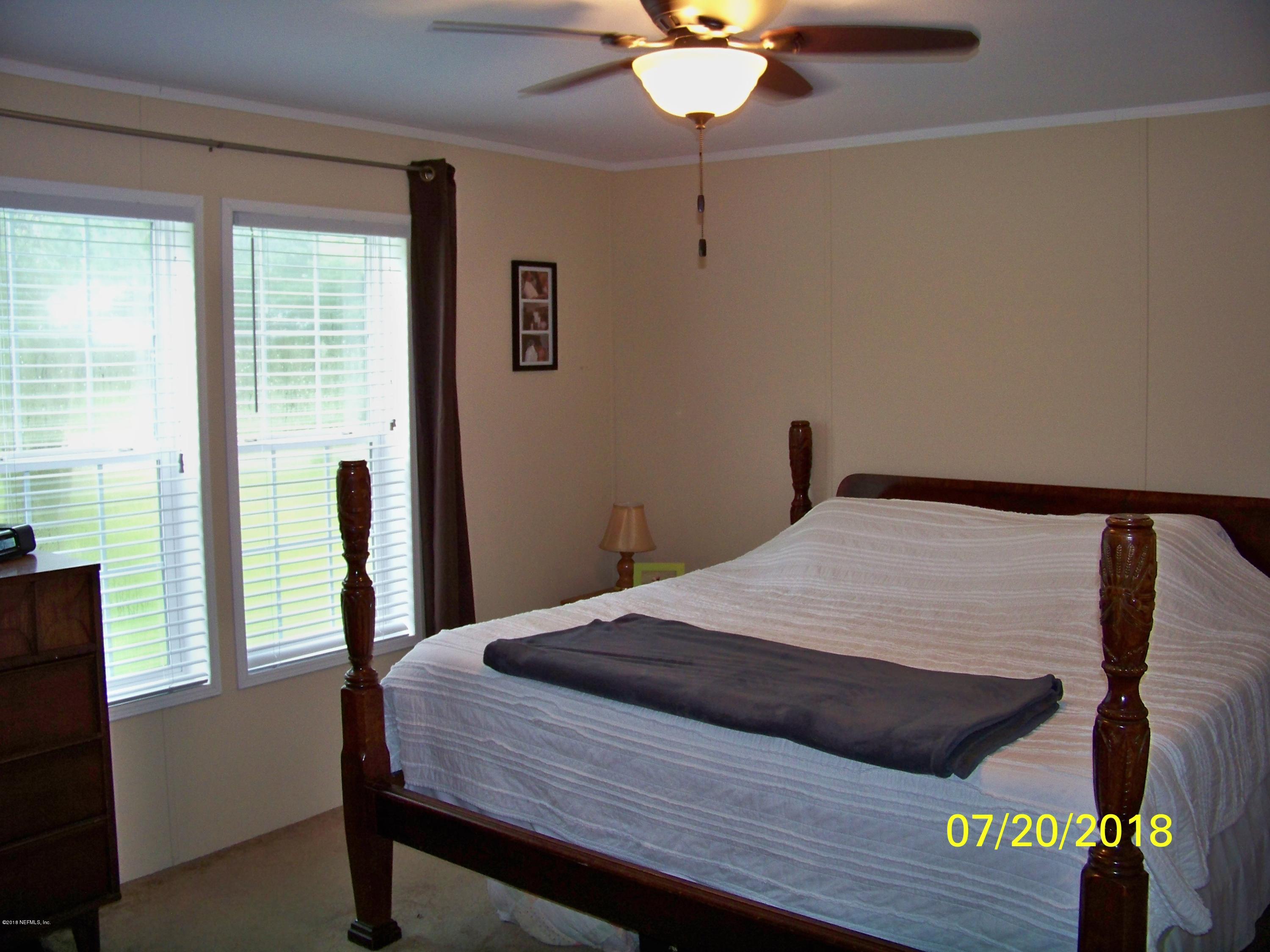 54314 Lawhon Road West Callahan, FL 32011 - Photo 8 of 30 a bedroom with a bed and a window