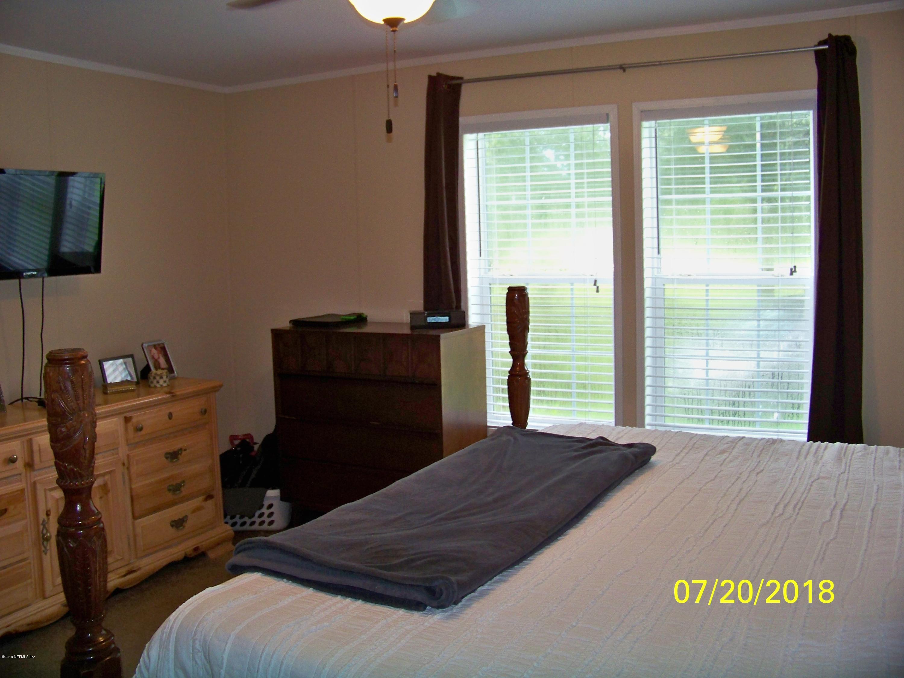 54314 Lawhon Road West Callahan, FL 32011 - Photo 9 of 30 a bedroom with a bed and a window