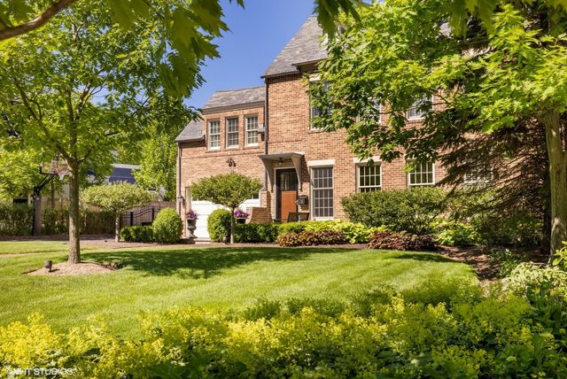 a kitchen with stainless steel appliances a stove a table and chairs