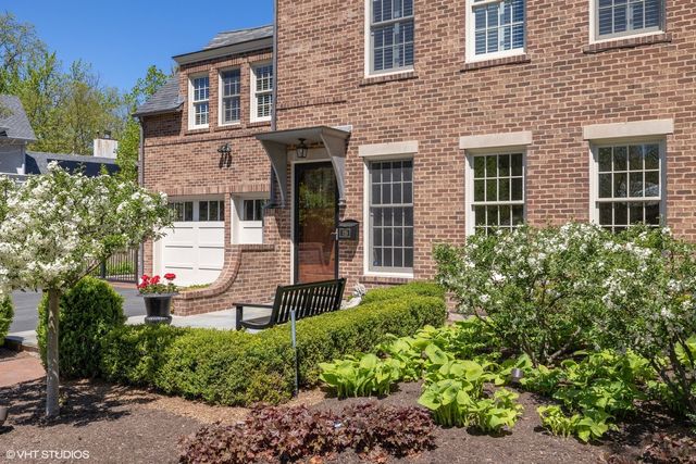 a kitchen with a stove a chandelier and wooden floor