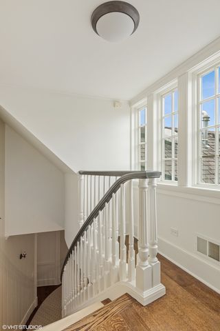 a view of a garden with an apartment building in the background
