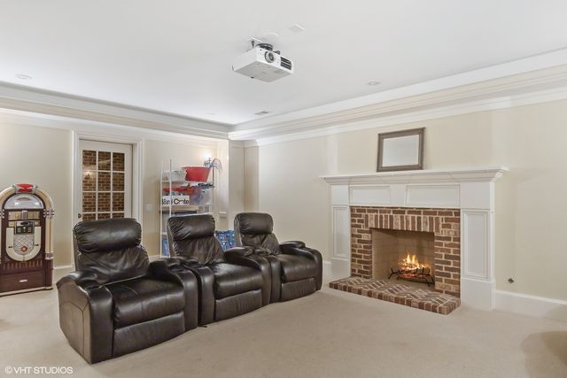 a view of swimming pool with large trees and plants