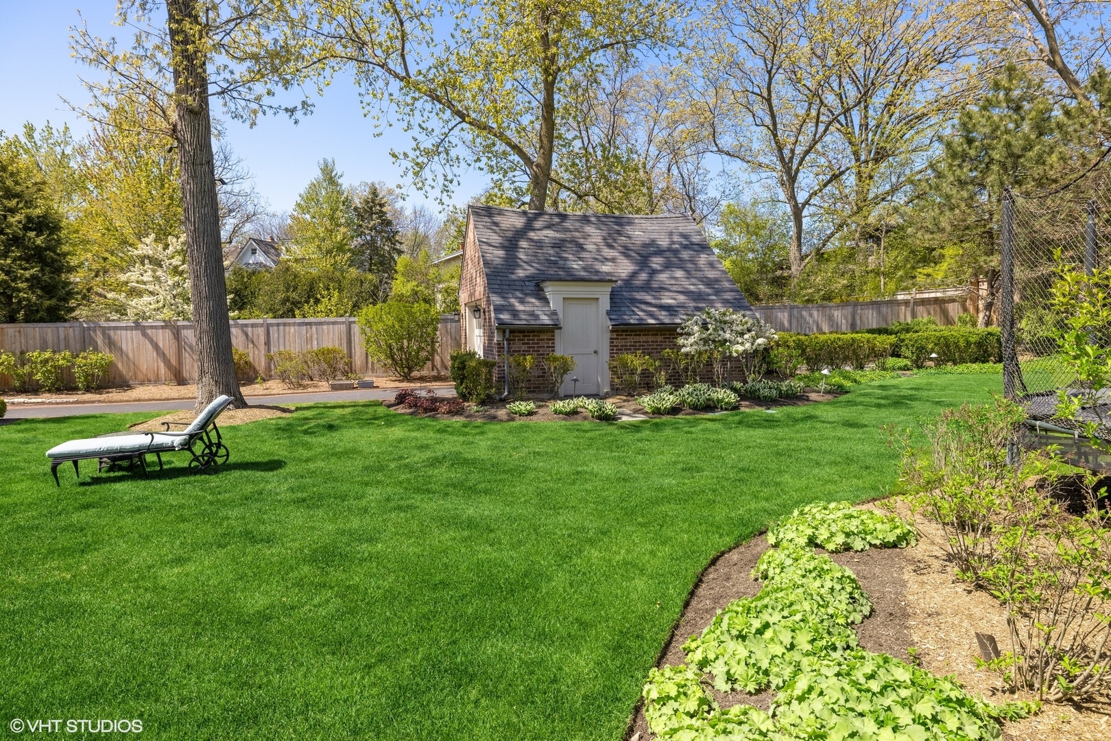 725 Walden Road Winnetka, IL 60093 - Photo 63 of 84 a view of a garden with an apartment building in the background