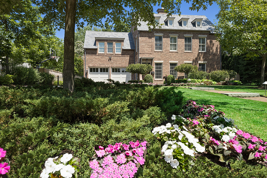 725 Walden Road Winnetka, IL 60093 - Photo 66 of 84 a front view of a house with a yard and fountain in middle of the green field