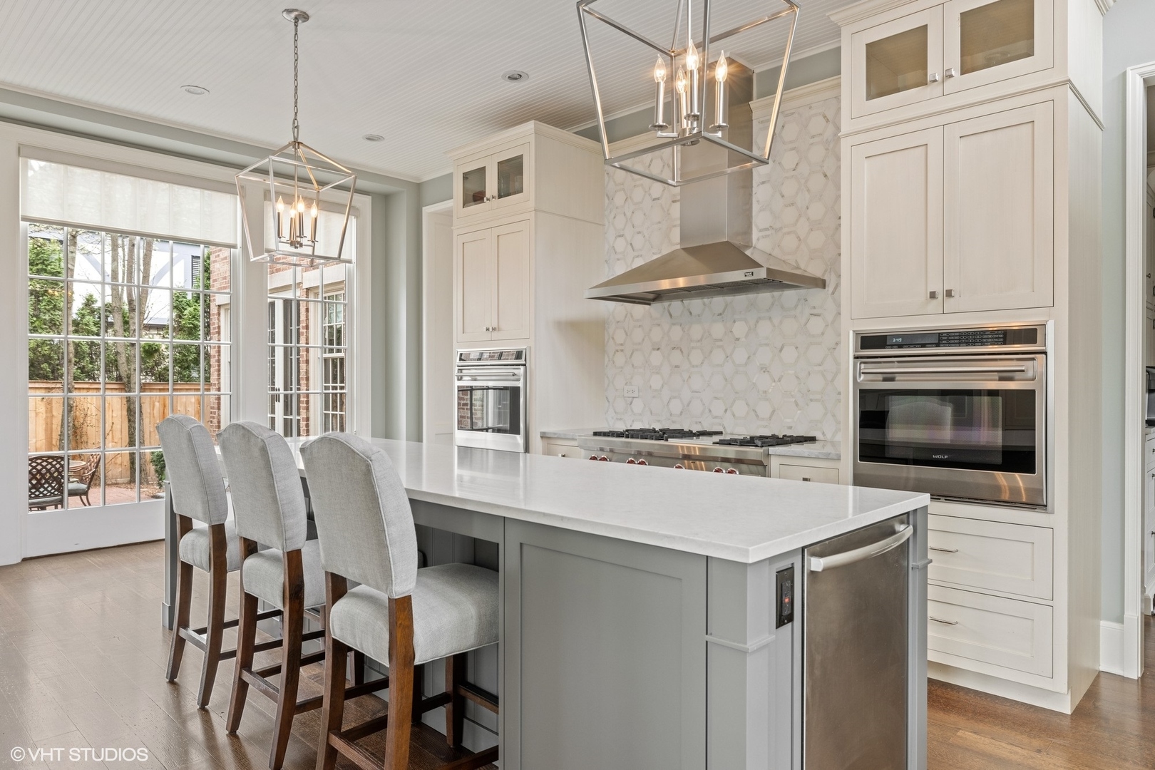 725 Walden Road Winnetka, IL 60093 - Photo 8 of 84 a kitchen with a stove a chandelier and wooden floor