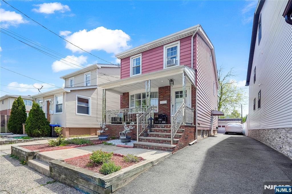 728 Devon Street Kearny, NJ 07032 - Photo 1 of 26 a front view of a house with garden