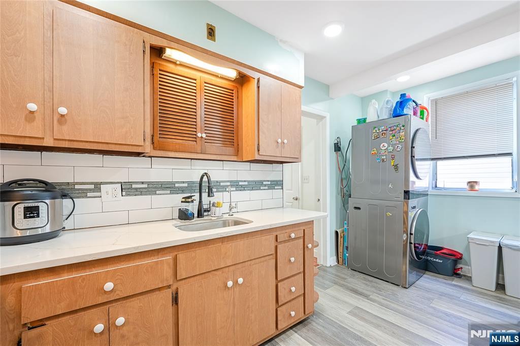 728 Devon Street Kearny, NJ 07032 - Photo 11 of 26 a kitchen with stainless steel appliances granite countertop a sink cabinets and wooden floor