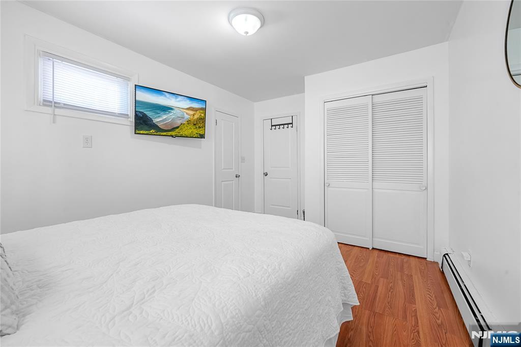 728 Devon Street Kearny, NJ 07032 - Photo 13 of 26 a bedroom with a bed and a painting on the wall