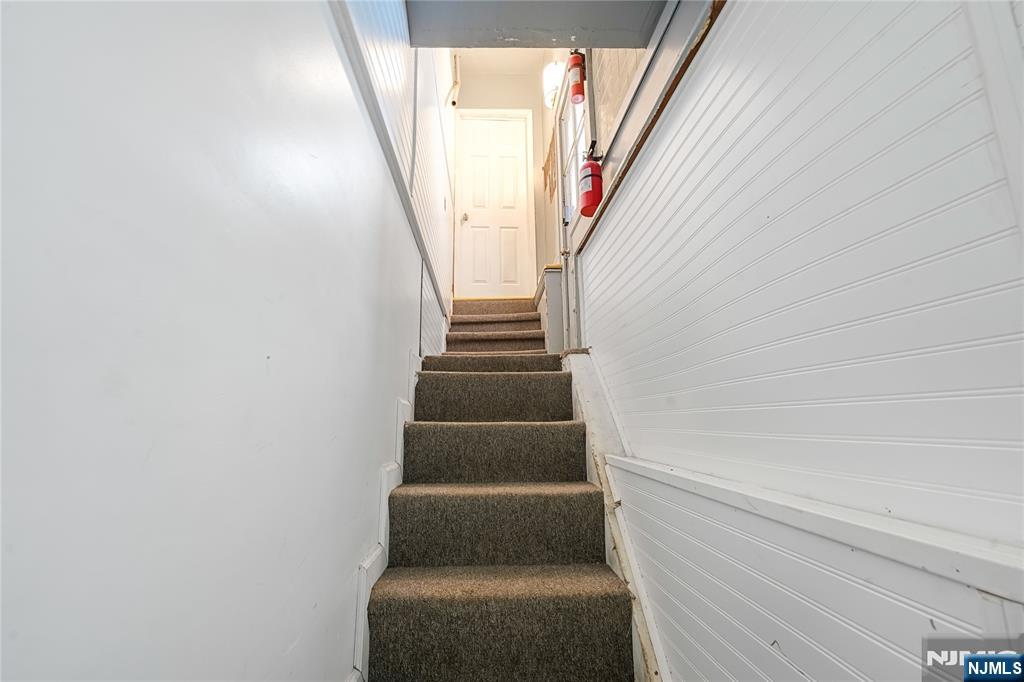 728 Devon Street Kearny, NJ 07032 - Photo 14 of 26 a view of staircase with white walls and white door