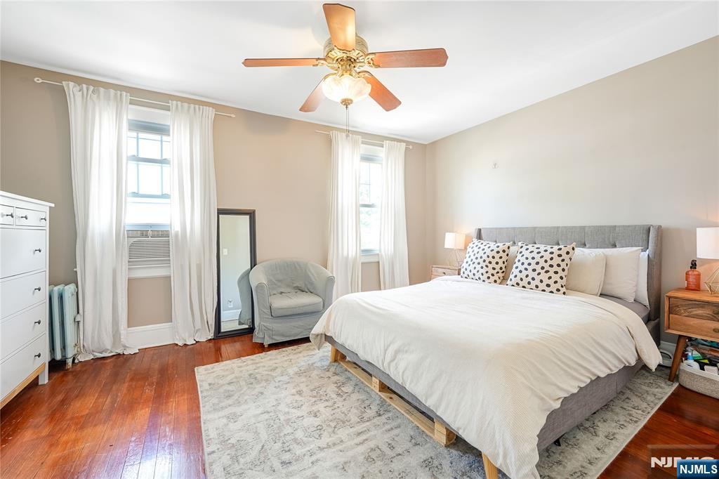 728 Devon Street Kearny, NJ 07032 - Photo 17 of 26 a bedroom with a bed and a chandelier