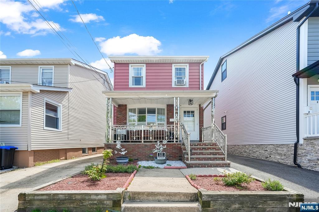 728 Devon Street Kearny, NJ 07032 - Photo 2 of 26 a front view of a house with garden