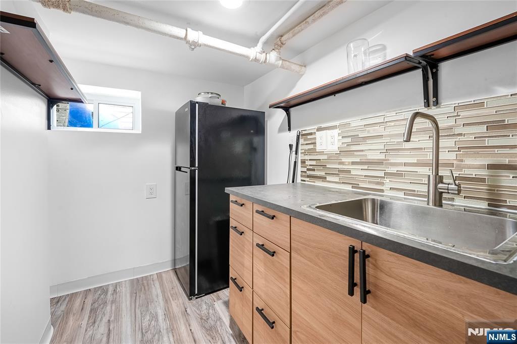 728 Devon Street Kearny, NJ 07032 - Photo 21 of 26 a kitchen with stainless steel appliances granite countertop a refrigerator and a sink