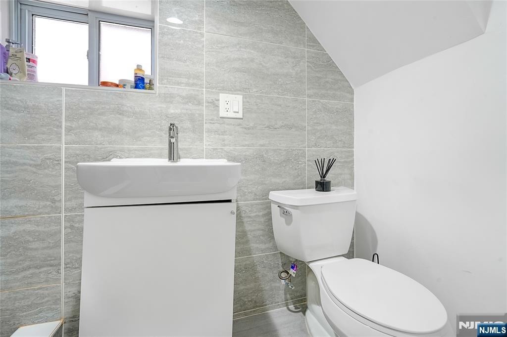 728 Devon Street Kearny, NJ 07032 - Photo 22 of 26 a white toilet sitting next to a white sink