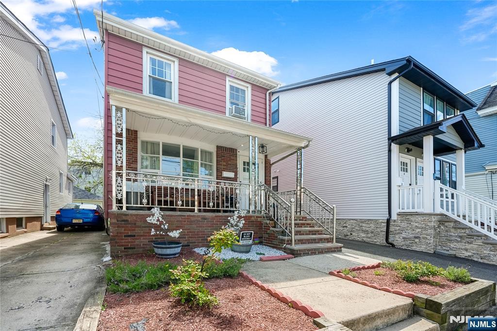 728 Devon Street Kearny, NJ 07032 - Photo 3 of 26 a front view of a house with garden