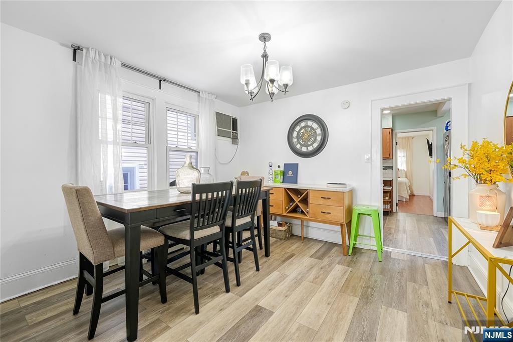 728 Devon Street Kearny, NJ 07032 - Photo 7 of 26 a view of a dining room and livingroom with furniture wooden floor and a clock