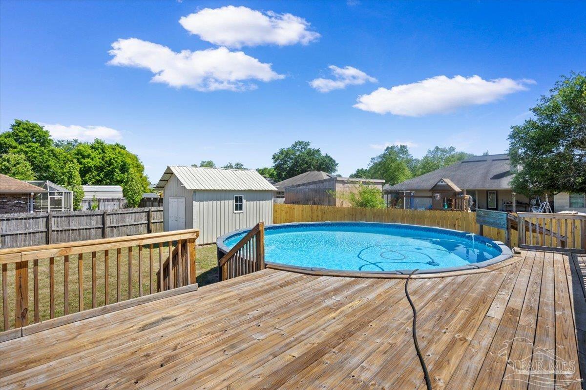 4015 Berry Circle Pace, FL 32571 - Photo 41 of 48 a view of a swimming pool with a lounge chairs