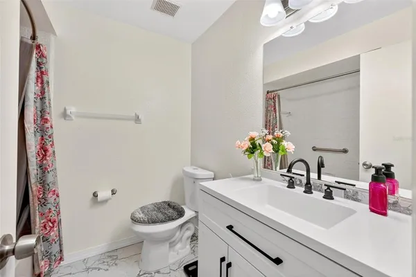 a bathroom with a bath tub with a shower
