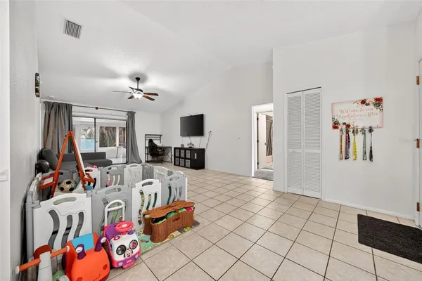 a bedroom with a large bed and a ceiling fan