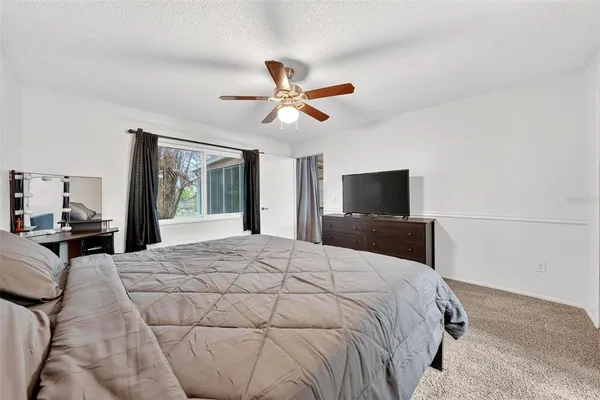 a bathroom with a sink vanity granite toilet and a shower