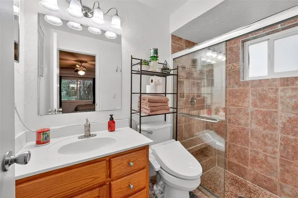 a bathroom with a sink vanity and mirror