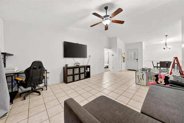 a living room with furniture and a floor to ceiling window