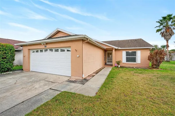 a living room with furniture and large windows