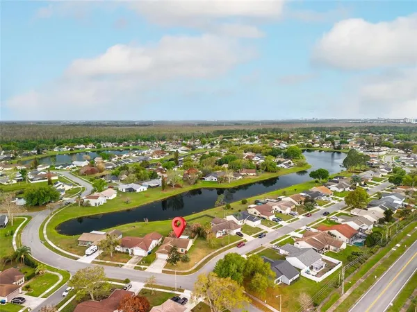 an aerial view of a house with a garden and swimming pool