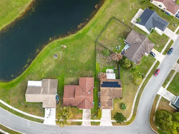 a aerial view of a house with swimming pool and large trees