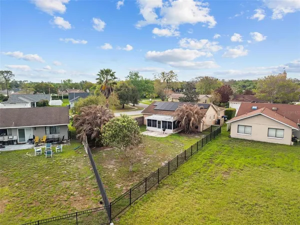 a view of a backyard with plants and lake view