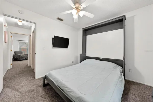 a bedroom with a bed and a chandelier