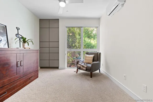 a view of a room that has a bed and a window in it