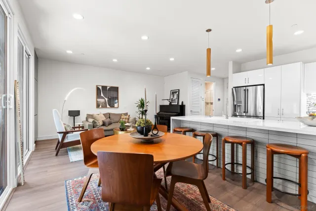 a view of a dining room with furniture and a chandelier