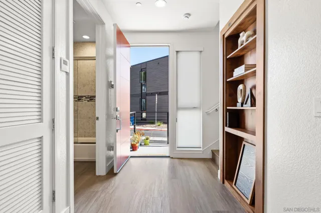 a view of a hallway view with wooden floor and staircase