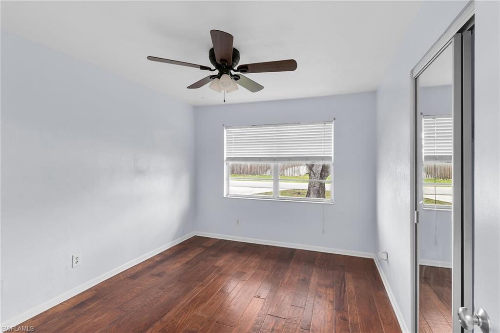 4502 22nd Place Southwest Naples, FL 34116 - Photo 16 of 30 Spare room with dark wood finished floors and a ceiling fan