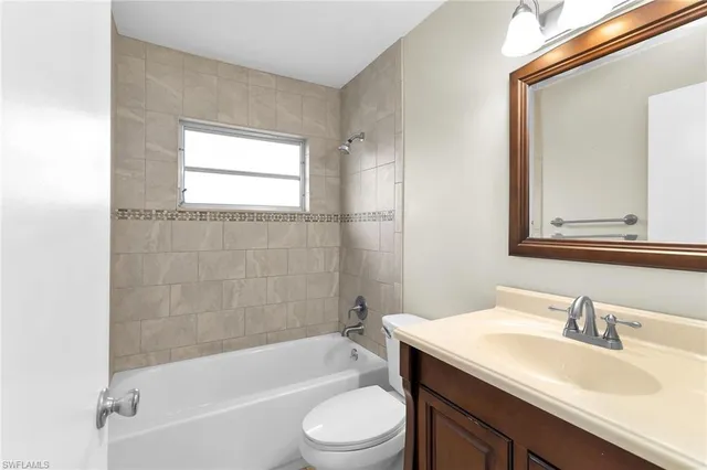 an empty room with a window and a ceiling fan