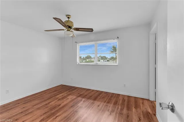 a view of a livingroom with a window and wooden floor