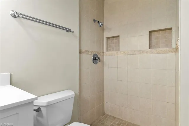 a kitchen with kitchen island white cabinets appliances and a fireplace