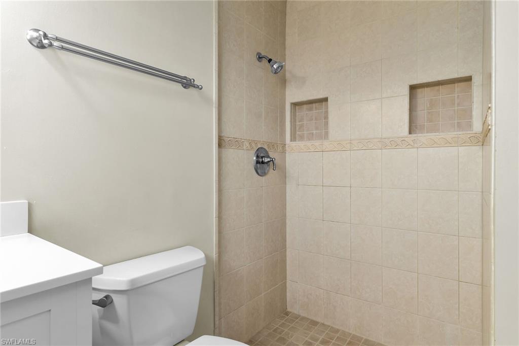 4502 22nd Place Southwest Naples, FL 34116 - Photo 22 of 30 Bathroom with a tile shower and vanity