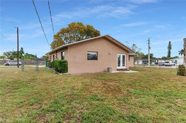 a front view of house with yard and trees around