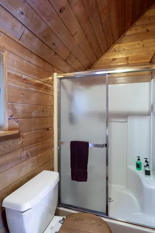 a bathroom with a bathtub and shower