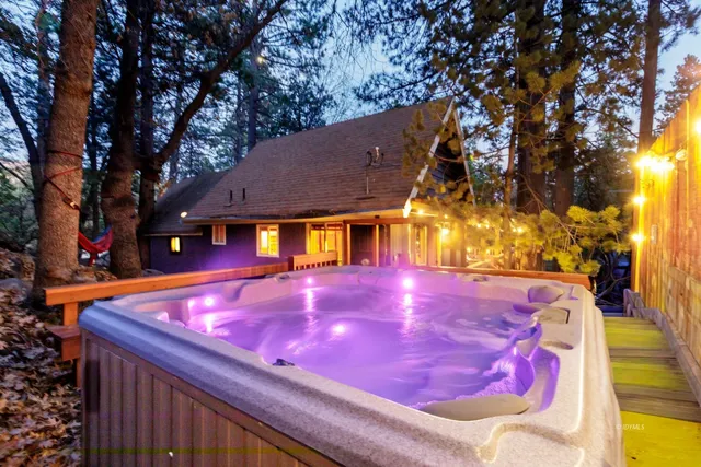 a view of a tennis ground with large trees