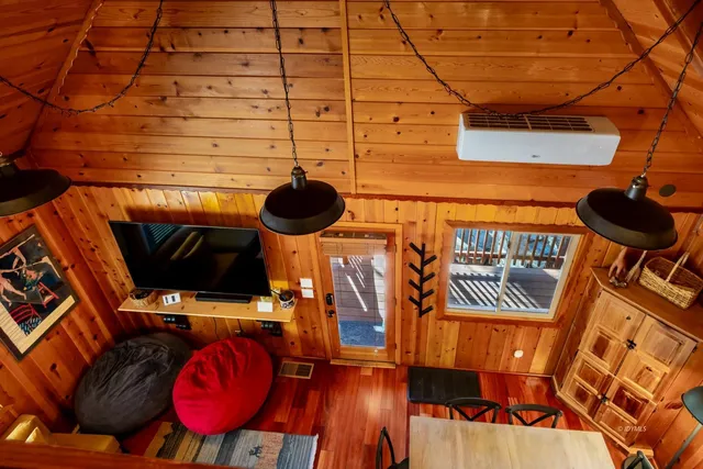 a view of a balcony with chairs and wooden floor