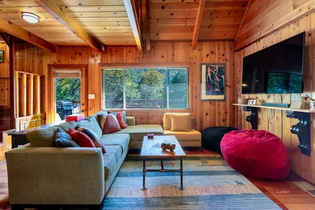 a living room with furniture a rug and a large window