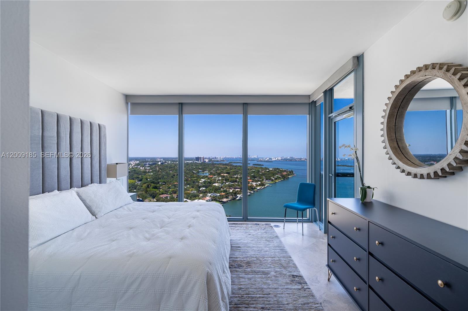 601 Northeast 36th Street, Unit 2908 Miami, FL 33137 - Photo 14 of 19 a spacious bedroom with a large bed and a dresser