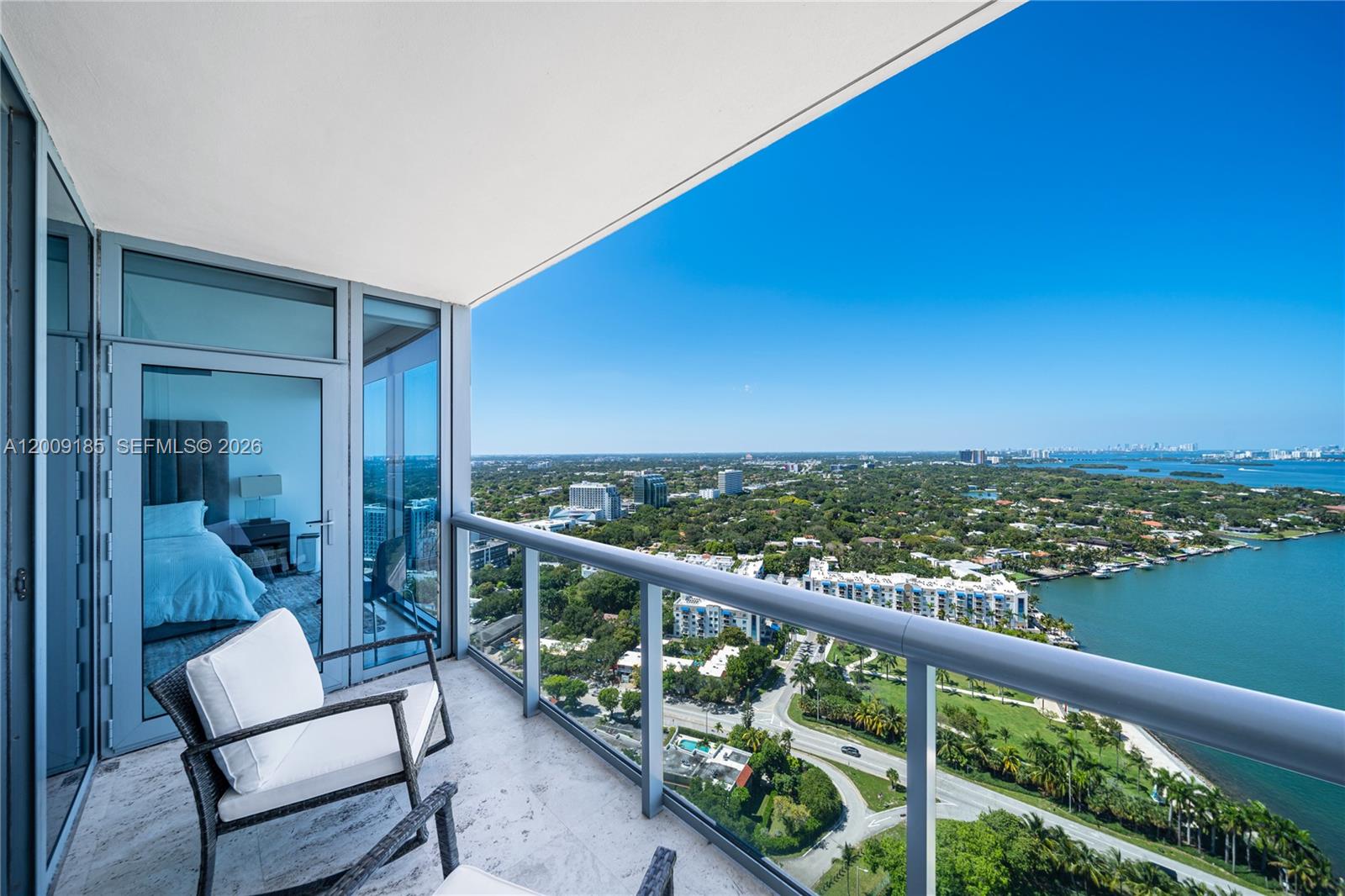 601 Northeast 36th Street, Unit 2908 Miami, FL 33137 - Photo 15 of 19 a view of a balcony with chair and wooden floor