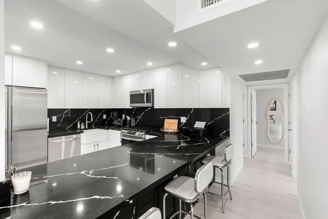 a large kitchen with a table and chairs