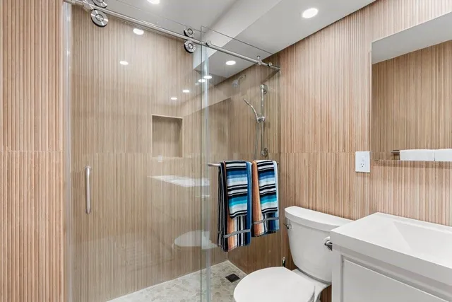 a white toilet sitting next to a bathroom sink