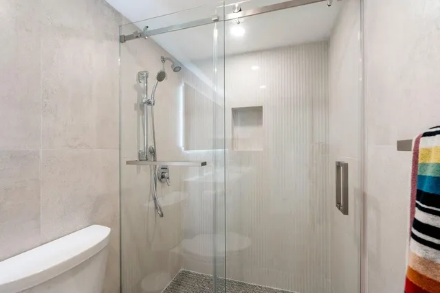 a bathroom with a shower toilet and sink