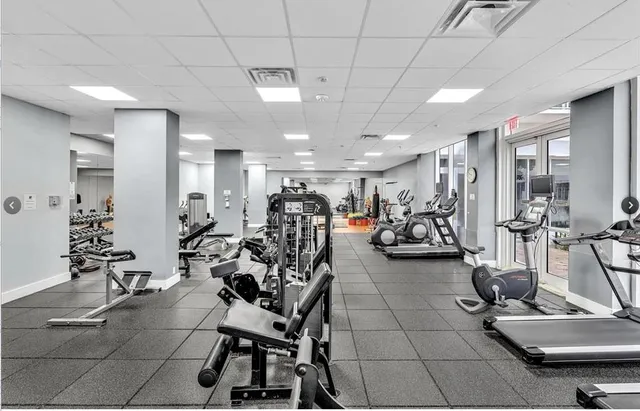 a room with gym equipment and lots of equipment